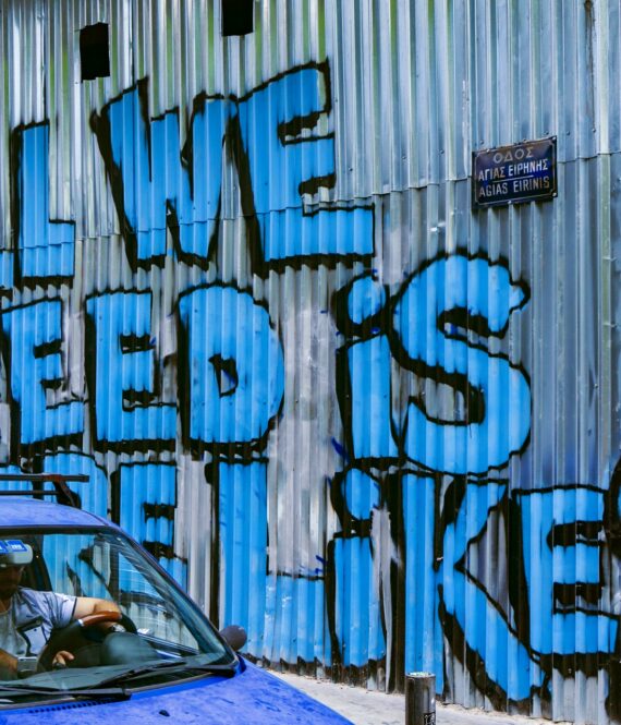 Graffiti reads: All we need is more likes. Social media misinformation spreads rapidly.