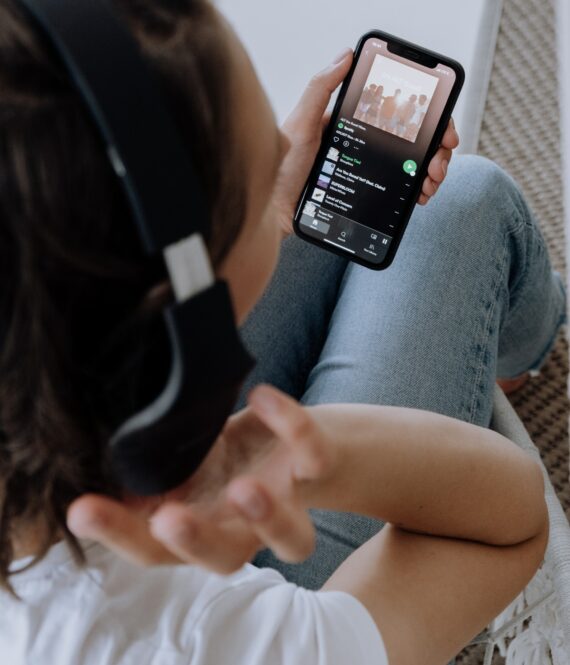 Neil Young pulled his songs from Spotify. Young person listening to music via Spotify on phone. Photo by cottonbro from Pexels